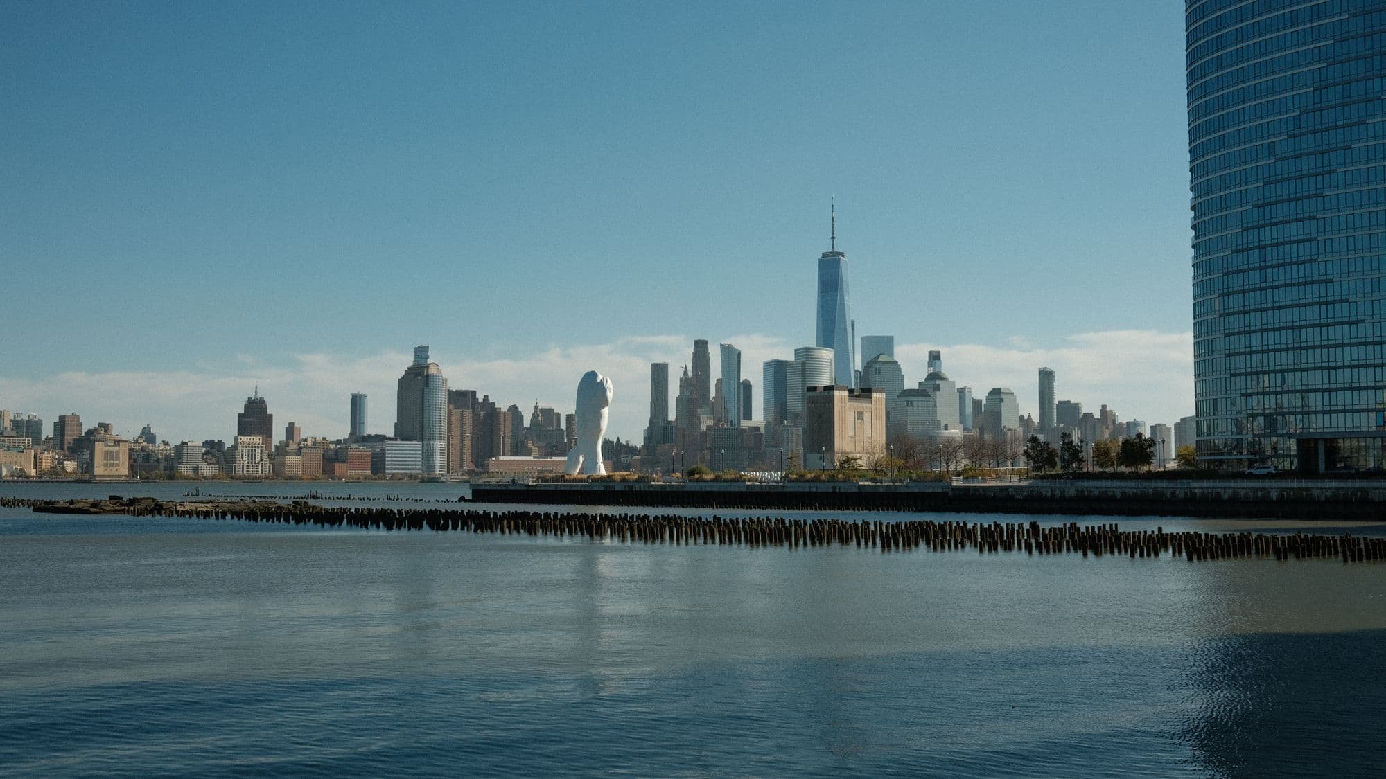 A major city skyline across the water seen from the waterfront