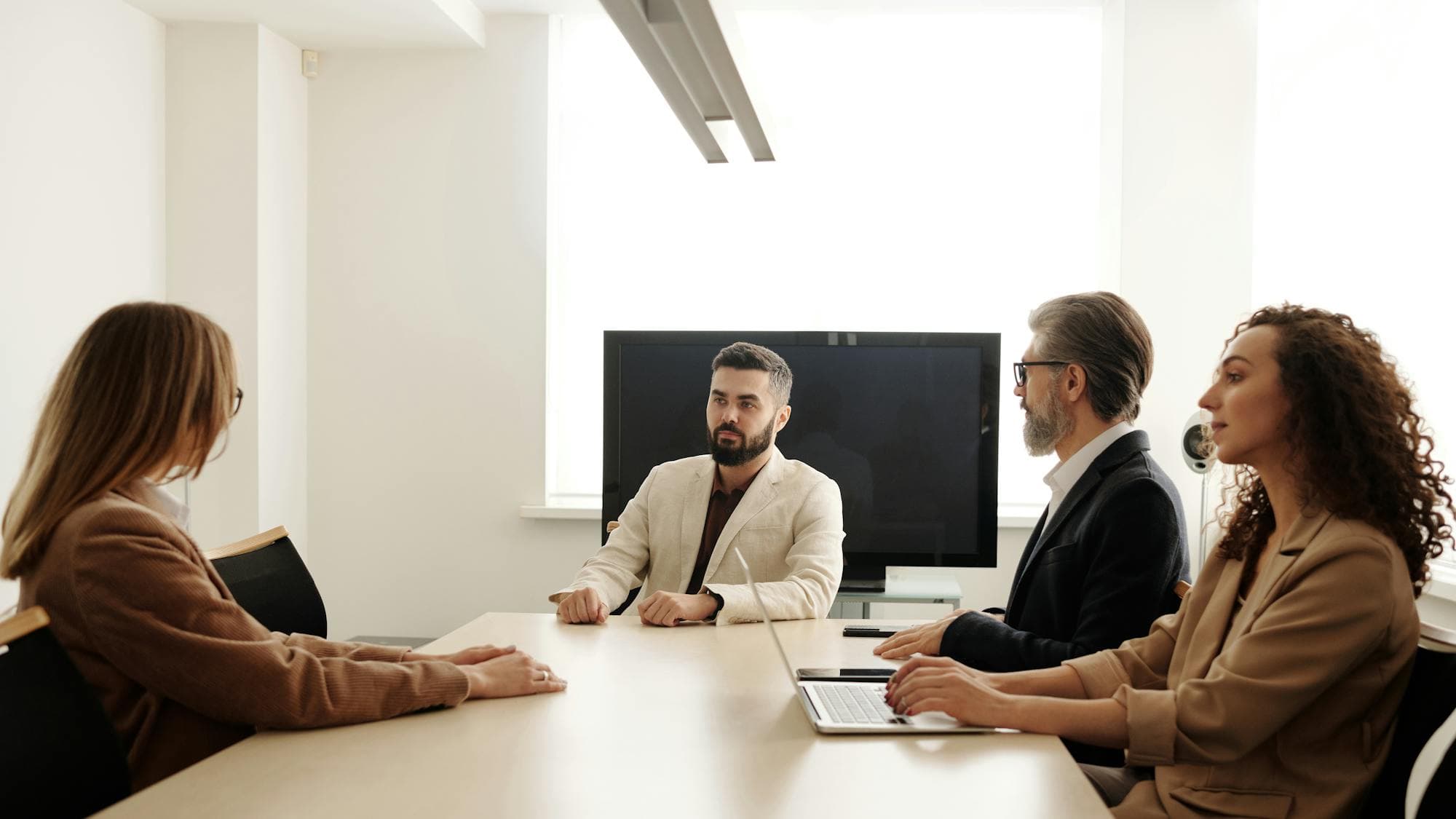 A small team working through a plan around a meeting table